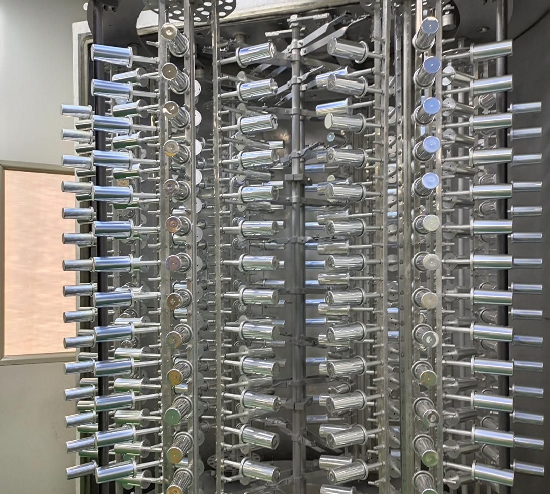 Vacuum metallization rack loaded with coated components